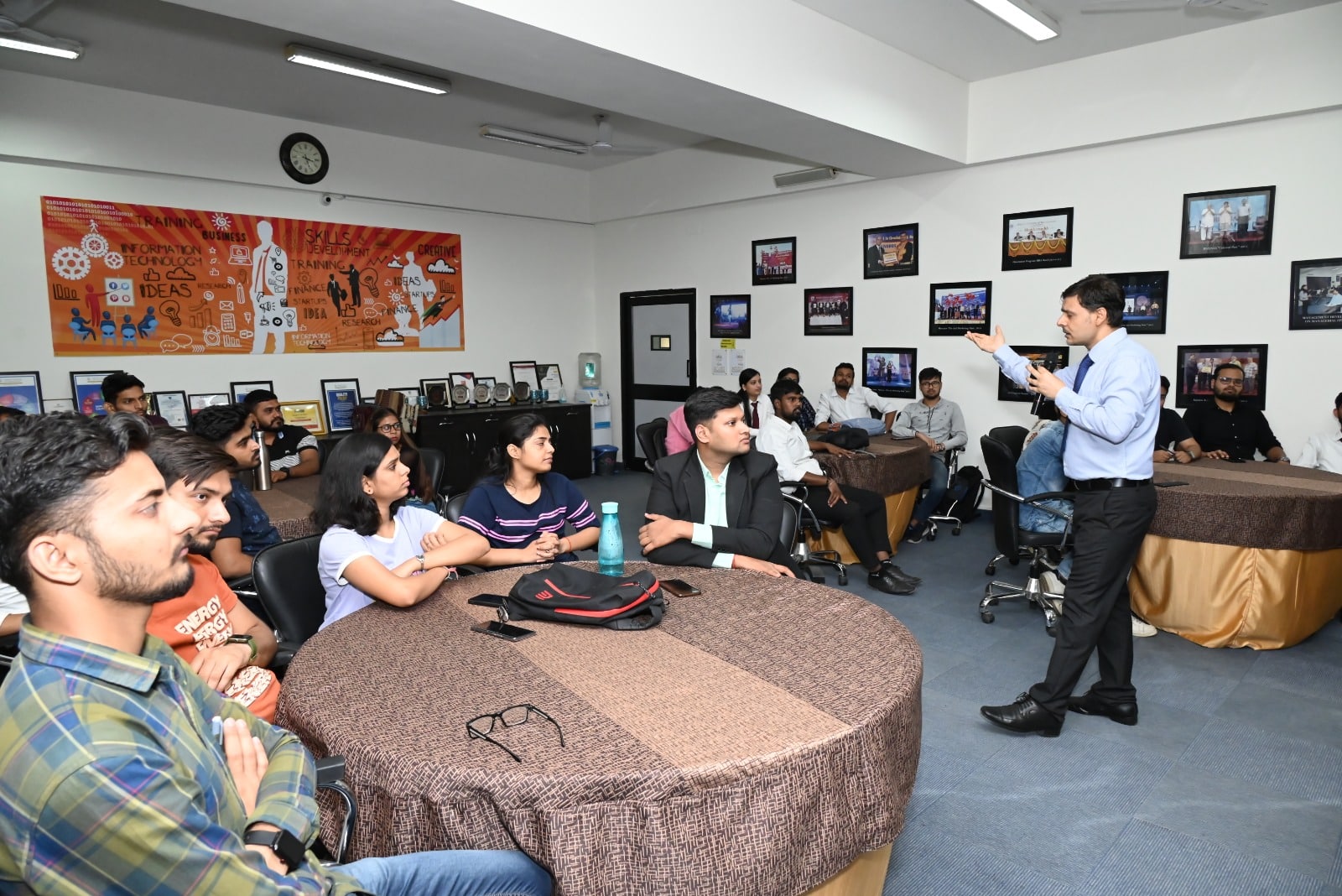 A wide shot of the JIM Auditorium, filled with attentive students, focused on Rohin Koul as he shares his experiences and expertise in e-commerce.