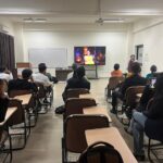 MBA students in a classroom at Jaipuria Institute of Management, Ghaziabad, focused on a "Shark Tank" episode during the financial education event.