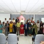 A group of Jaipuria Institute's faculty and staff posing for a photo at the "Secrets of Joyful Living" event organized by Brahma Kumaris.