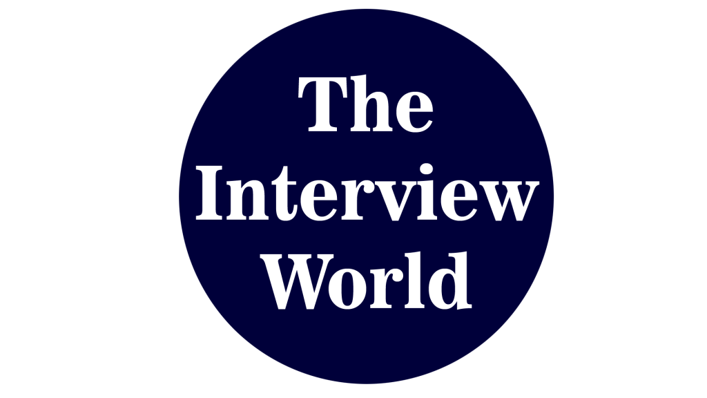 The Interview World logo: dark blue circle with white text 'The Interview World' on a black background.