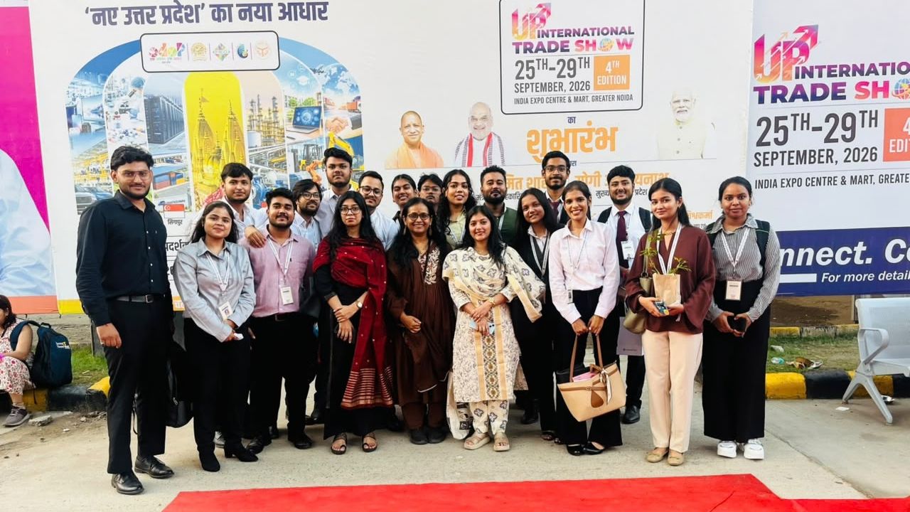 MBA Students Gain Industry Exposure at UP International Trade Show 2026 1 - Jaipuria Institute of Management, Indirapuram Ghaziabad Group of students and professionals posing for a photo at the UP International Trade Show banners in the background.—Banners show event dates and logos in the backdrop.